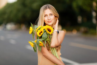 Young woman holding flower