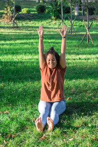 Smiling woman is doing yoga exercise outside in a park. concept of healthy lifestyle.