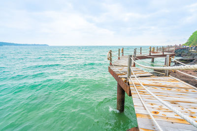 Rock and wood bridge by the sea