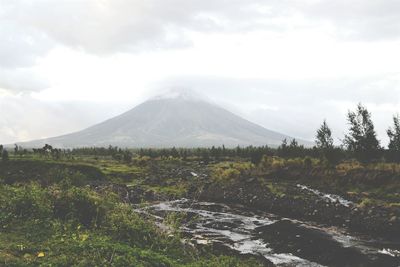 Scenic view of mountains against cloudy sky