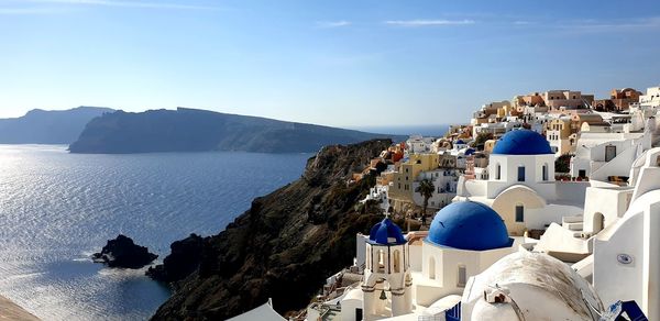 Panoramic shot of townscape by sea against sky