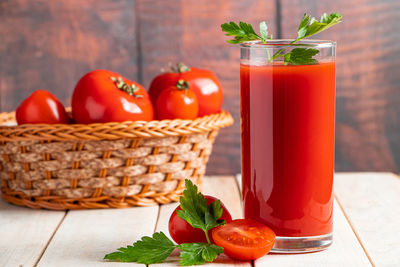 Diet tomato juice with parsley on a wooden background. vegan vegetable smoothie.