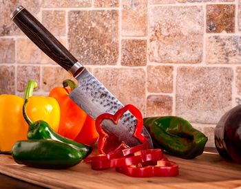 Close-up of bell peppers and knife on table