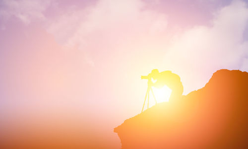 Close-up of silhouette man against sky during sunset