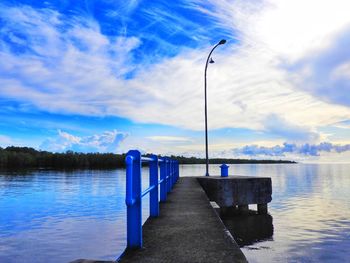 Pier over lake against sky