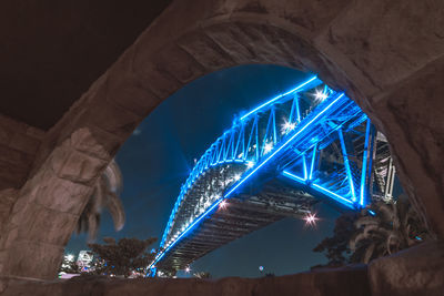 Low angle view of illuminated ferris wheel at night