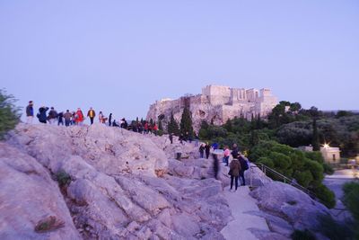 People walking in park against sky