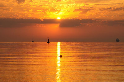 Scenic view of calm sea at sunset