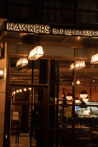 Illuminated lamp post in restaurant at night