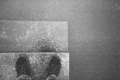 Low section of man standing on floor