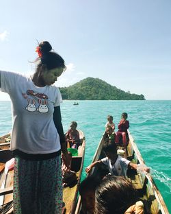 People standing by sea against sky