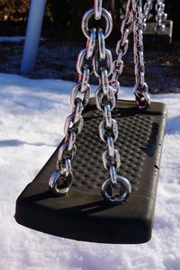 Close-up of chain swing during winter