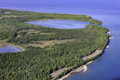 High angle view of land and sea against sky