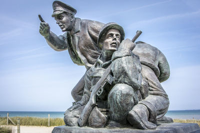 Low angle view of statue against sky