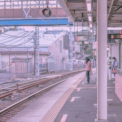 Man standing on railroad station platform