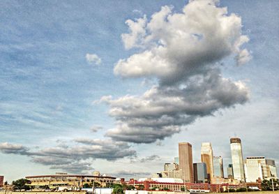 Buildings against cloudy sky