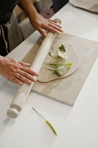 Pottery workshop in studio. hands working with clay on the table. adult learning to do ceramic