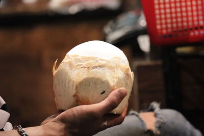 Close-up of hand holding ice cream cone