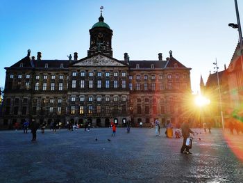 People walking on street at sunset in amsterdam