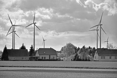 Traditional windmill on field against sky