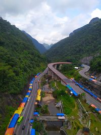 High angle view of road amidst trees against sky