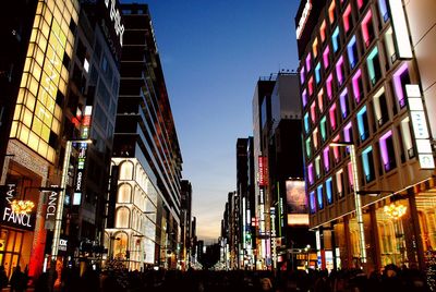 Low angle view of illuminated buildings against sky at night