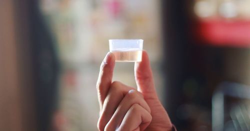 Close-up of hand holding coffee cup