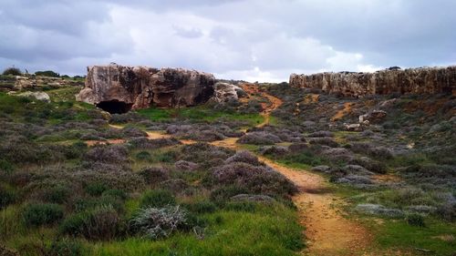 Rock formations on landscape against sky