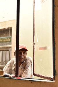 Man looking through window