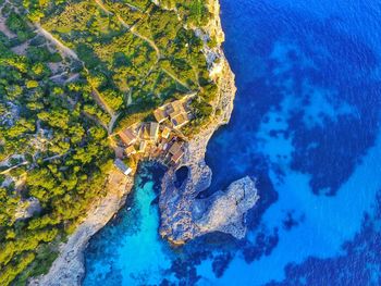 Aerial view of land by sea