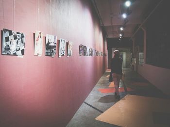 View of illuminated woman in corridor