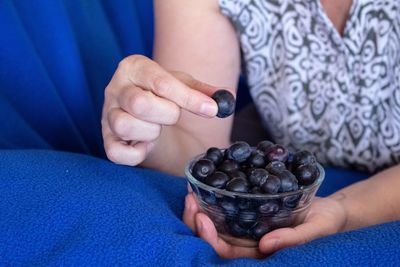 Midsection of woman holding fruit