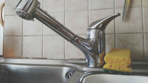 Close-up of faucet in bathroom