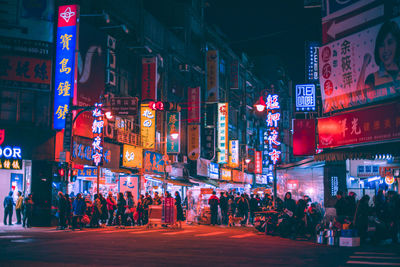 Crowd on city street at night