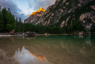 Scenic view of lake by trees against sky