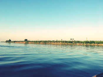 Scenic view of sea against clear blue sky