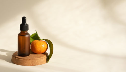 Cropped hand of woman holding medicines on table