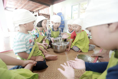 High angle view of people sitting on table