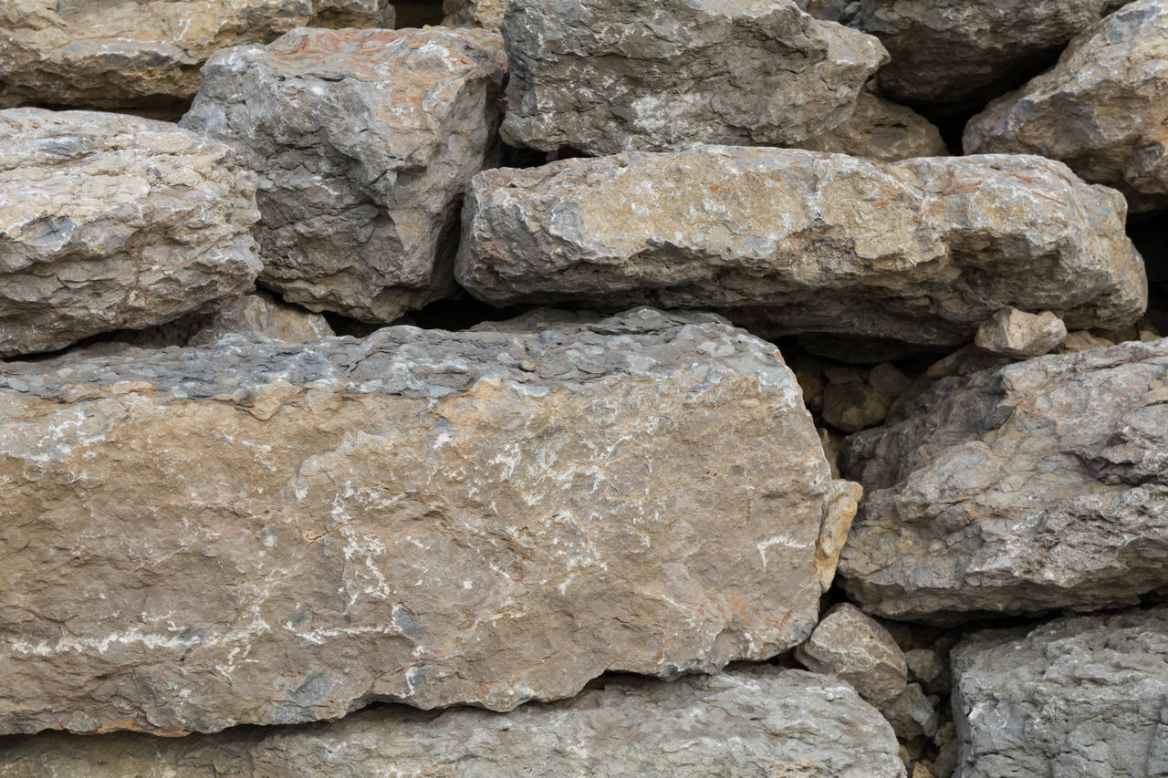 FULL FRAME SHOT OF ROCKS AND STONE WALL