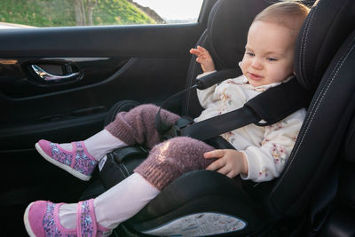 Low section of woman sitting in car