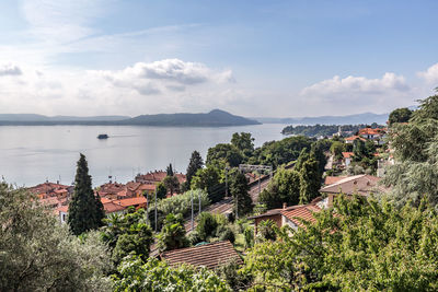 Panoramic view of townscape by sea against sky