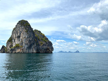 Scenic view of rock formation in sea against sky