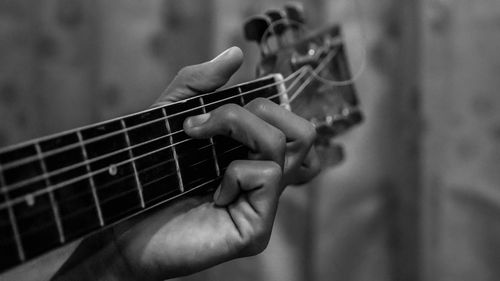 Close-up of hands playing guitar