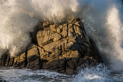 Sea waves splashing on rocks