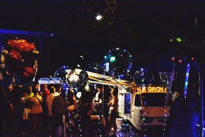 Crowd at music concert in city at night