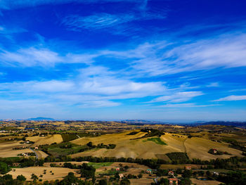 Aerial view of landscape against blue sky