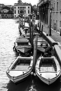Boats moored in river
