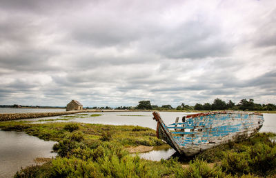 Abandoned boat by river