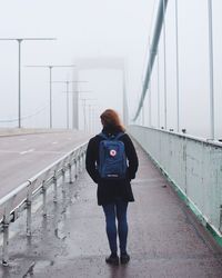 Full length of woman standing on sidewalk