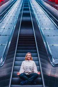 Portrait of smiling woman on escalator